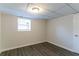 Finished basement bedroom with neutral walls and wood-look flooring at 2950 The Meadows Way, Atlanta, GA 30349