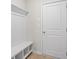 Laundry room with built-in bench, shelving, and patterned flooring at 1068 Rose Dr, Marietta, GA 30060