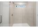 Large walk in shower with neutral tile and glass door at 1068 Rose Dr, Marietta, GA 30060