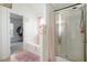 Spacious bathroom featuring a bathtub, separate shower, and soft pink accents at 6476 Snowden Dr, Atlanta, GA 30349