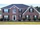 Brick two-story house with black shutters and a well-maintained lawn at 6476 Snowden Dr, Atlanta, GA 30349