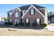 Attractive two-story brick home with black shutters and a landscaped front yard at 6476 Snowden Dr, Atlanta, GA 30349