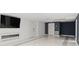 Finished basement featuring a large TV, fireplace, and marble floors at 201 Nina Cir, Locust Grove, GA 30248