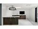 Modern basement kitchenette with dark cabinetry and marble countertops at 201 Nina Cir, Locust Grove, GA 30248