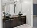 Modern bathroom with double vanity, vessel sinks, and dark brown cabinets at 201 Nina Cir, Locust Grove, GA 30248