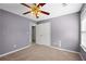 Well-lit bedroom with ceiling fan and double doors at 201 Nina Cir, Locust Grove, GA 30248