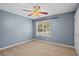 Spacious bedroom with ceiling fan and neutral walls at 201 Nina Cir, Locust Grove, GA 30248