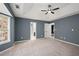 Bright bedroom with ceiling fan, neutral walls, and carpet flooring at 201 Nina Cir, Locust Grove, GA 30248