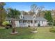 House exterior featuring a two-story home with a landscaped yard and palm trees at 201 Nina Cir, Locust Grove, GA 30248