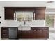Kitchen with dark brown cabinets, quartz countertops, and stainless steel sink at 201 Nina Cir, Locust Grove, GA 30248