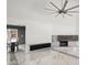 Living room boasts a marble floor, fireplace, and ceiling fan at 201 Nina Cir, Locust Grove, GA 30248