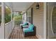 Porch with teal wicker seating and a wooden floor at 201 Nina Cir, Locust Grove, GA 30248