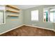 Cozy bedroom with wall-mounted shelves and neutral carpeting at 654 Garner Sw Rd, Lilburn, GA 30047