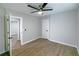 Bright bedroom with ceiling fan, wood-look flooring, and white doors at 2330 Beecher Cir, Atlanta, GA 30311