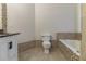 Bathroom with a toilet, vanity, and a tiled tub/shower combo at 4970 Newpark Nw Ln, Acworth, GA 30101