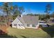 Aerial view of a gray house with a large backyard and surrounding trees at 312 Brook Hollow Ln, Loganville, GA 30052
