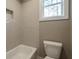 Clean bathroom with a shower/tub combo and tile surround at 312 Brook Hollow Ln, Loganville, GA 30052