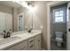 Bathroom boasts double vanity with marble countertop at 312 Brook Hollow Ln, Loganville, GA 30052