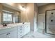 Elegant bathroom with double vanity, marble shower, and modern fixtures at 312 Brook Hollow Ln, Loganville, GA 30052
