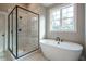 Spa-like bathroom featuring a soaking tub and a large walk-in shower at 312 Brook Hollow Ln, Loganville, GA 30052