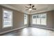 Bright bedroom with hardwood floors and multiple windows at 312 Brook Hollow Ln, Loganville, GA 30052
