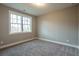Spacious bedroom with large window and neutral carpeting at 312 Brook Hollow Ln, Loganville, GA 30052