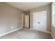 Spacious bedroom with double doors and carpeting at 312 Brook Hollow Ln, Loganville, GA 30052
