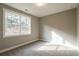 Well-lit bedroom with a large window and neutral wall color at 312 Brook Hollow Ln, Loganville, GA 30052