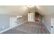 Large bonus room with carpet, multiple closets, and AC unit at 312 Brook Hollow Ln, Loganville, GA 30052