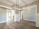 Formal dining room with hardwood floors, chandelier, and large window at 312 Brook Hollow Ln, Loganville, GA 30052