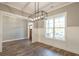 Formal dining room features hardwood floors, white wainscoting and chandelier at 312 Brook Hollow Ln, Loganville, GA 30052