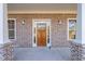 Rustic wooden front door adds warmth to the home's exterior at 312 Brook Hollow Ln, Loganville, GA 30052