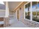Brick front porch with a wooden door and white columns at 312 Brook Hollow Ln, Loganville, GA 30052