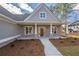 Inviting front porch with brick columns and a wooden door at 312 Brook Hollow Ln, Loganville, GA 30052