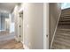 Bright hallway with carpeted stairs and hardwood flooring at 312 Brook Hollow Ln, Loganville, GA 30052