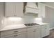 White shaker cabinets, quartz countertops, and gas cooktop at 312 Brook Hollow Ln, Loganville, GA 30052