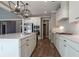 Modern kitchen with white cabinets, quartz countertops, and stainless steel appliances at 312 Brook Hollow Ln, Loganville, GA 30052