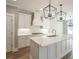 Modern kitchen with white cabinets, quartz countertops, and stainless steel appliances at 312 Brook Hollow Ln, Loganville, GA 30052