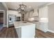 Modern kitchen with white cabinets, quartz countertops, and stainless steel appliances at 312 Brook Hollow Ln, Loganville, GA 30052