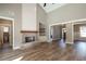 Spacious living room featuring a brick fireplace, built-in shelving, and hardwood floors at 312 Brook Hollow Ln, Loganville, GA 30052