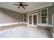 Covered patio with ceiling fan and brick details at 312 Brook Hollow Ln, Loganville, GA 30052