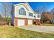 Front exterior of a two-story home with a two-car garage, brick and siding exterior, and a teal front door at 482 Chase Marion Way, Mcdonough, GA 30253