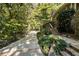 Brick and stone walkway leading to home with mature trees surrounding property at 123 Cherry St, Roswell, GA 30075