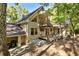 House exterior showcasing a deck, stone walkway, and wooded setting at 123 Cherry St, Roswell, GA 30075