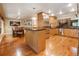 Open concept kitchen with island, hardwood floors, and stainless steel appliances at 123 Cherry St, Roswell, GA 30075