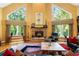 Spacious living room with hardwood floors, stone fireplace, and abundant natural light at 123 Cherry St, Roswell, GA 30075