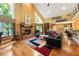 Spacious living room with hardwood floors, stone fireplace, and large windows at 123 Cherry St, Roswell, GA 30075