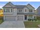 Two story house with gray siding, double garage, and manicured lawn at 189 Osier Dr, Mcdonough, GA 30252