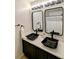 Modern bathroom with dual sinks, black matte fixtures, and contemporary mirrors at 1317 Liberty Nw Pkwy, Atlanta, GA 30318