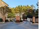 Gated community entrance with brick pillars and trees at 1317 Liberty Nw Pkwy, Atlanta, GA 30318